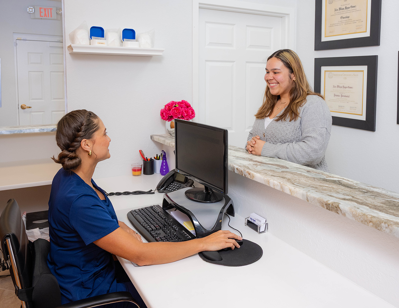 Front desk help for new smile featuring adhesive dentistry.